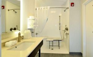 a white bathroom with a shower and a sink at Hampton Inn Santee-I-95 in Santee