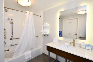 a bathroom with a tub and a sink and a shower at Hampton Inn Santee-I-95 in Santee