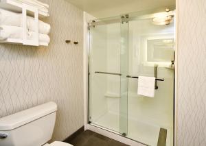 a bathroom with a toilet and a glass shower at Hampton Inn Santee-I-95 in Santee