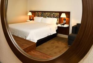 a hotel room with a bed and a mirror at Hampton Inn Santee-I-95 in Santee
