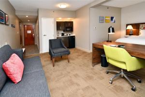 a hotel room with a bed and a desk and chairs at Hampton Inn Santee-I-95 in Santee