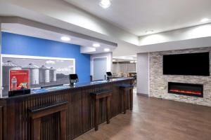 a bar with a fireplace and a flat screen tv at Hampton Inn Sanford in Sanford