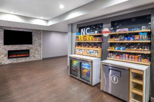 a store with a fireplace and a display of drinks at Hampton Inn Sanford in Sanford