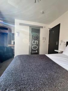 a bedroom with a bed with a sign on the wall at Rooms Kingswood in Bristol