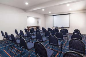 a conference room with chairs and a screen at Hampton Inn Sanford in Sanford