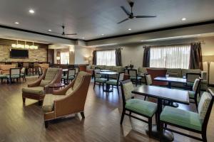 a restaurant with tables and chairs in a room at Hampton Inn Vernon in Vernon