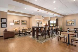 a living room with a bar and a dining room at Hampton Inn Spearfish in Spearfish