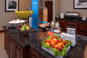 a kitchen with a bowl of fruit on a counter at Hampton Inn Lincoln in Lincoln