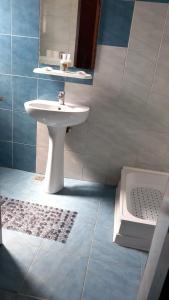 a bathroom with a white sink and a shower at CASA ADELA in Tulcea +23 photos