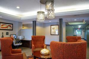 a waiting room with orange chairs and a table at Hampton Inn St. Louis-Chesterfield in Chesterfield