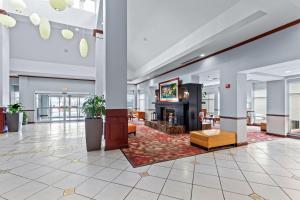 a lobby with a fireplace in a building at Hilton Garden Inn Starkville in Starkville