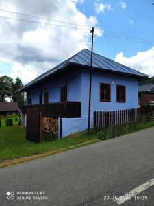 a blue house on the side of a road at Chalupa Levandula in Šumiac