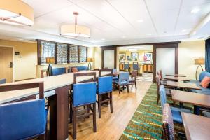 a dining room with tables and blue chairs at Hampton Inn St Charles St Peters in St. Charles
