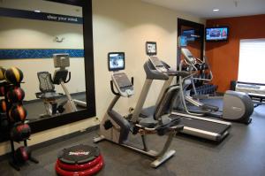 a gym with two exercise bikes and a mirror at Hampton Inn Stow in Stow