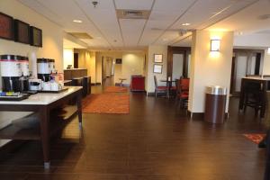 a lobby of a restaurant with tables and chairs at Hampton Inn Sumter in Sumter