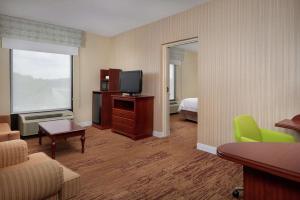 a hotel room with a bed and a television at Hampton Inn Shrewsbury in Shrewsbury
