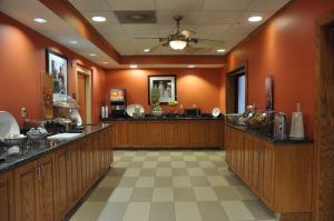 a hair salon with orange walls and wooden counters at Hampton Inn Stony Creek in Stony Creek