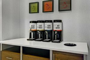a row of wine bottles sitting on a shelf at Hampton Inn & Suites by Hilton Syracuse Dewitt in East Syracuse