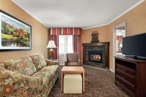 a living room with a couch and a fireplace at Homewood Suites Syracuse-Liverpool in Liverpool