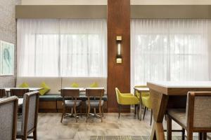 a dining room with a table and chairs and a couch at Hampton Inn & Suites Tacoma/Puyallup in Puyallup