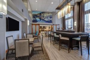 a dining room with a long table and chairs at Hampton Inn & Suites Tulare in Tulare
