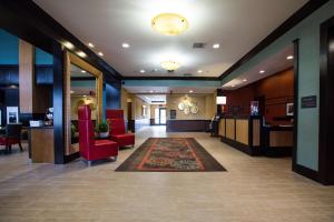 a lobby of a hospital with red chairs and a rug at Hampton Inn & Suites Toledo/Westgate in Toledo