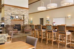 a living room with a table and chairs and a fireplace at Hampton Inn & Suites Tarpon Springs in Tarpon Springs