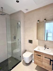 a bathroom with a shower and a toilet and a sink at Oasis Mehdia vue sur mer in Kenitra