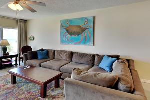 a living room with a couch and a table at Emerald Isle #106 in Pensacola Beach