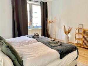 een slaapkamer met een bed met handdoeken erop bij Bright & central for 4 incl workspace in Bochum