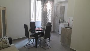 a kitchen with a table and chairs in a room at I Faraglioni Comfort Rooms in Terrasini