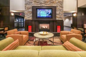 a lobby with couches and a fireplace with a tv at Hampton Inn and Suites Tulsa/Catoosa in Catoosa