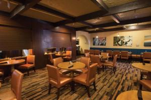 a restaurant with tables and chairs in a room at DoubleTree Suites by Hilton Tucson-Williams Center in Tucson