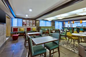 a dining room with tables and chairs at Hampton Inn Traverse City in Traverse City