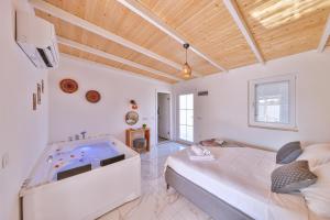 a bedroom with a large bed and a tv at Villa Ay in Kaş +64 photos