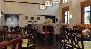 a restaurant with tables and chairs in a room at Hampton Inn & Suites-Knoxville/North I-75 in Knoxville