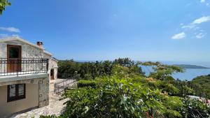 a house on a hill with a view of the ocean at Mountains Villa near Budva in Budva
