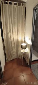 a small room with a toilet and a curtain at Villa féeric in Toulon