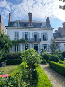 a large white house with a garden in front of it at Belle Fontaine in Bourges