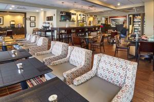 a restaurant with a row of chairs and tables at Hampton Inn Uniontown in Uniontown