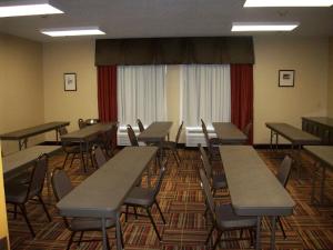 an empty classroom with desks and chairs and a window at Hampton Inn Uniontown in Uniontown +47 photos