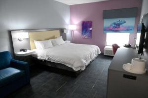 a bedroom with a bed and a chair and a couch at Hampton Inn Valdosta/Lake Park Area in Lake Park +17 photos