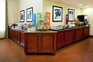 a lobby with a counter with food on it at Hampton Inn & Suites Venice Bayside South Sarasota in Venice