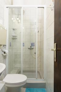 a bathroom with a shower with a toilet and a sink at Apartmani Šuki in Trogir