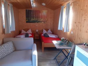 Habitación pequeña con sofá y mesa. en Schlafwagen Beachvolleyball, en Xanten