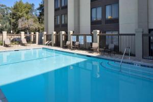 a large blue swimming pool in front of a building at Hampton Inn Los Angeles-West Covina in West Covina