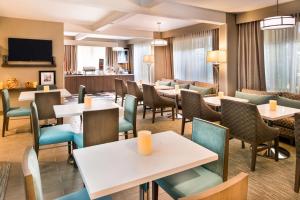 a restaurant with tables and chairs and a bar at Hampton Inn Los Angeles-West Covina in West Covina