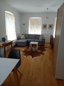 a living room with a couch and a table at Ferienwohnung Murtal in Sankt Lorenzen bei Knittelfeld