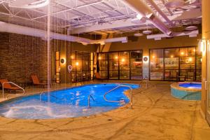 a pool in a building with a water feature at Hampton Inn Wheeling in Wheeling