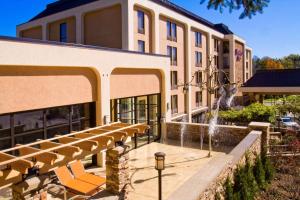 a building with a fountain in front of it at Hampton Inn Wheeling in Wheeling